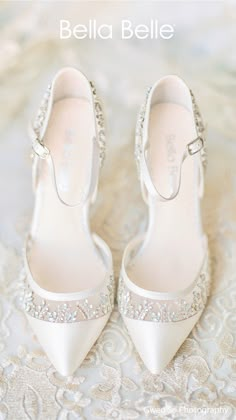 a pair of white shoes sitting on top of a lace covered table cloth with the words,