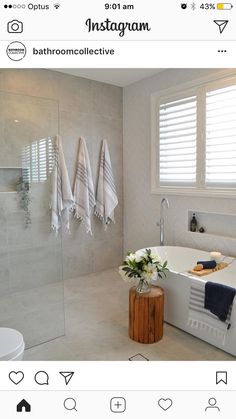 a white bath tub sitting next to a walk in shower