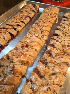 several pastries are lined up on a metal baking sheet and ready to be eaten