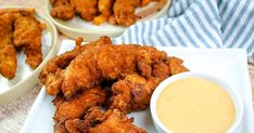 fried chicken with dipping sauce on a white plate