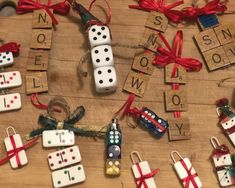 some dices and christmas decorations on a wooden table with red ribbon around them,