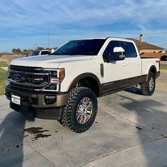 a white pickup truck parked in a driveway