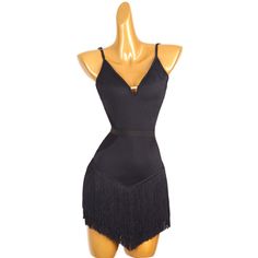 a mannequin wearing a black dress with fringes