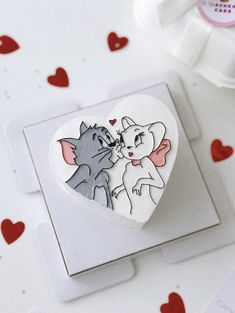 a heart shaped box with two cats on it