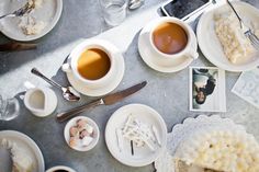 a table topped with plates and cups of coffee