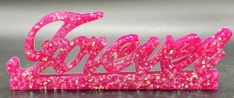 a pink glittered sign that says gonzo on it's side with the word gonzo spelled in cursive writing