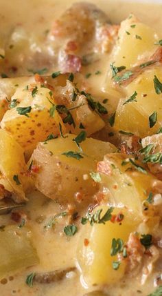 a white bowl filled with potatoes and meat covered in gravy, garnished with parsley