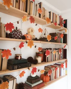 the bookshelves are filled with many different types of autumn leaves and decorations on them