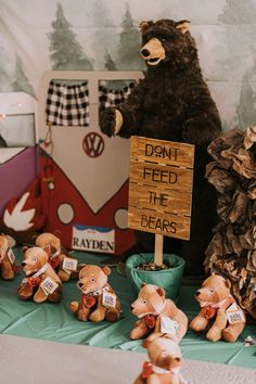 teddy bears are lined up on the table with a sign that says don't feed the bears