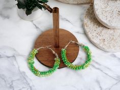 Colorful blend of three shades of green seed bead hoop earrings. Perfect for any outfit or holiday occasion! Makes for great lucky charm jewelry Green Round Beaded Earrings For Gift, Cheap Green Beaded Hoop Earrings, Green Beaded Small Hoop Earrings, Nickel-free Green Beaded Earrings For Parties, Nickel-free Small Hoop Green Beaded Earrings, Beaded Hoop Earrings, Wire Wrapped Earrings, Beaded Hoops, Lucky Charm