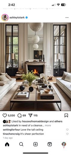 a living room filled with furniture and a fire place in the middle of a room