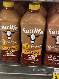 three bottles of fairlife dha omga - 3 chocolate milk on the shelf