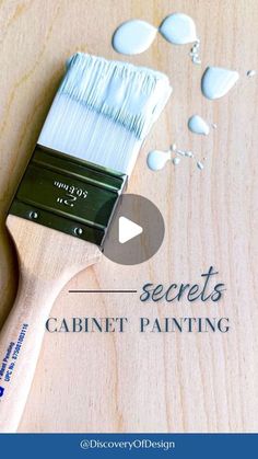 a paint brush with the words secrets cabinet painting on it and an image of water drops