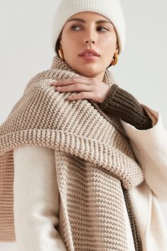 Make your style A LOT cozier with our extra-long Bronx Scarf. Bronx is both knit from ultra-soft French Merino Wool mix to warm your soul and fashioned extra long to make a statement. Wrap this Merino wool scarf around and around for volume, or wear her draped over your shoulders to lend your look texture and drama. This soft wool scarf also doubles perfectly as an airplane blanket.[SPLIT] Julia, in light beige, is 5'10" (178 cm) tall, wearing size XS. Natalee, in medium grey, is 5'10" (178 cm) Tan And White Striped Scarf, Warm Knit Scarves For Fall, Cozy Knitted Scarves For Fall, Soft Knit Wool Scarves For Fall, Knit Scarves For Fall Cold Weather, One Size Knit Scarves, Beige Knitted Scarves One Size, Soft Knit Scarves For Fall, Knit Wool Scarves For Fall