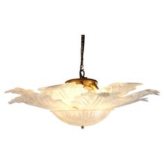 a chandelier hanging from the ceiling with two birds on it