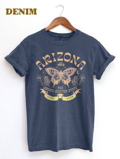 Thanks for checking out this Arizona State Butterfly graphic T-Shirt. This Retro BOHO design has the Arizona Swallowtail Butterfly  at the Main Motif for this Bohemian aesthetic Souvenir Tee.. Throw this shirt on with the Beautiful Grand Canyon State in your mind and soul. For the Comfort Colors 1717, The soft-washed, garment-dyed fabric has a weathered vintage look that hold up well, but soften over over time for a warm look. This fully customized tee is made 100% with ring-spun cotton. The dou Boho Tshirt, Boho Tshirts, Butterfly Shirt, Swallowtail Butterfly, Bohemian Aesthetic, Butterfly Shirts, Butterfly Graphic, Boho Design, Arizona State