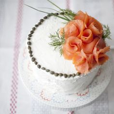 a white cake with orange flowers on top