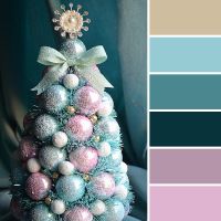 a blue and pink christmas tree with ornaments on it's top is surrounded by other colors