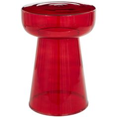 a red vase sitting on top of a white table