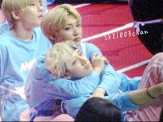 group of young men sitting next to each other at a basketball game