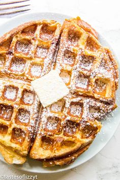 waffles with powdered sugar and butter on a plate