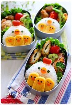 two bowls filled with rice, meat and veggies shaped like chickens sitting on top of each other