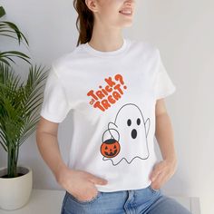 a woman wearing a ghost t - shirt with a ladybug on the chest