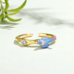 This beautifully detailed ring boasts a bird in bright shades of multicolored enamel. The intricate flawless enamel work coupled with a sparking stone, make this an eye-catching piece.Carat Weight: 0.059 ctStone Size: 2 mmStone Type: Jeulia® StoneNumber of Stones: 1 Stone Shape: RoundStone Color: Aquamarine BlueWeight: 2 gWidth: 20.4 mmHeight: 3.7 mmThickness: 1 mmMaterial: 925 SilverPlating Color: Yellow Gold Gemstone Enamel Ring, Fine Jewelry Enamel Multi-stone Ring Gift, Enamel Multi-stone Rings As A Gift, Dreamy Garden, Detailed Ring, Bird Design, Quality Jewelry, Sterling Silver Ring, Silver Ring