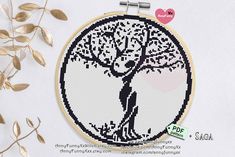 a cross stitch pattern with an image of a tree