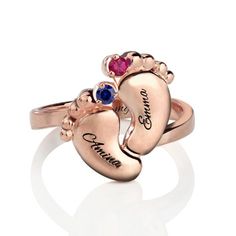 two heart shaped rings with names engraved on the front and back, set in rose gold