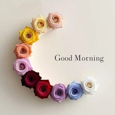 colorful paper flowers arranged in a circle with the words good morning written below it on a white background