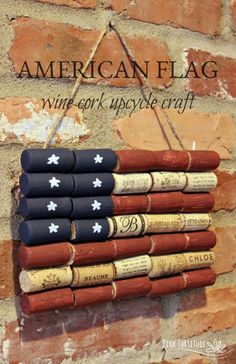 an american flag made out of wine corks hanging on a brick wall with the words,