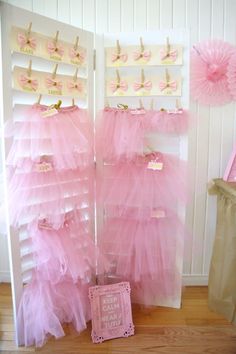 there are pink tulle skirts hanging on the wall