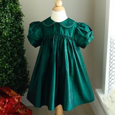 This Strasburg Emerald Dress In A Girl's Size 24 Months Is Most Gorgeous!!! Made Of 100% Fine Silk. Sweet Peter Pan Collar That Has A Matching Double Layer Silk Trim That Has Been Hand-Faggoted (High-End Quality). Within The Hand-Faggoting Stitching Are White Pearls- Such Beautiful And Unique Craftsmanship!! Bodice Is Trimmed In Matching Piping Also. Short Puff Sleeves Have A Matching Silk Band For A Classy Tailored Look. Upper Button Back With Matching Silk Fabric Buttons. Fits Size24 Months To Baptism Dress With Ruffles And Peter Pan Collar, Vintage Green Christmas Dress Toddler, Vintage Dress With Ruffle Hem And Doll Collar, Vintage Dress With Doll Collar For Dress-up, Emerald Dress, Vintage Doll Collar Fitted Dress, Pearl Collar, Emerald Dresses, Fabric Buttons