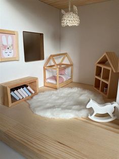 a doll house with furniture and accessories on the floor, including a rocking horse toy