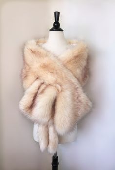 a white fur stole on a mannequin dummy with text below it that reads, champagne faux fur bridal wrap, light brown fur wedding fur