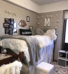 a dorm room with two beds and pictures on the wall above them, along with other furniture