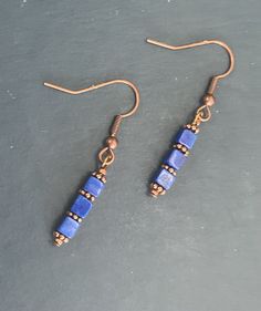 "These are special lapis earrings that are made with copper accents. The copper and cobalt blue are a beautiful combination. They are perfect to wear with blue jeans and add a pretty accent when you dress  up. Each earring has three lapis square cubes and copper spacers and a copper ear wire. They would be a special gift, because every one wears blue and lapis is an especially pretty gemstone. 1\" drop" Blue Copper Wire Wrapped Earrings, Nickel-free Blue Copper Jewelry, Simple Bead Earrings, Royal Blue Earrings, Cube Earrings, Sundance Jewelry, Lapis Jewelry, Lapis Earrings, Beaded Earrings Diy