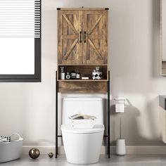 a white toilet sitting in a bathroom next to a wooden cabinet with doors on it