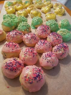 there are many different kinds of cookies on the table together, including one with sprinkles