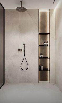 a bathroom with an open shower and shelves on the wall, along with a black faucet