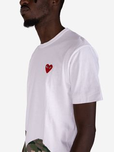 Building a wardrobe that's both iconic and effortless? Look no further than the quintessential Comme des Garçons Play White T-Shirt, now available at Urbanstaroma. rafted from premium cotton for unparalleled softness and breathability, this t-shirt offers exceptional comfort you'll love all day long. The classic ribbed neck and clean silhouette ensure timeless style, making it a versatile piece that seamlessly transitions from casual weekends to dressed-up days. But it's the signature Comme des Cdg Play, Build A Wardrobe, Comme Des Garcons Play, Boot Pumps, Mm6 Maison Margiela, Sweater Coats, White Tshirt, Women Brands, Birkenstock