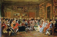 an image of a group of people sitting in a room with paintings on the wall