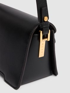 Find MARNI Trunkaroo Leather Shoulder Bag on Editorialist. The MARNI Trunkaroo Leather Shoulder Bag features a front flap with a clasp closure. It has three internal compartments and one internal card slot. The bag measures 11cm in height, 17cm in width, and 9cm in depth. It has an adjustable strap and gold-colored metal hardware. Timeless Square Flap Bag With Detachable Strap, Timeless Rectangular Saddle Bag With Detachable Handle, Timeless Flap Satchel With Gold-tone Hardware, Rectangular Flap Bag With Metal Hardware For Business, Rectangular Leather Saddle Bag With Magnetic Closure, Designer Saddle Bag With Brass Hardware For Everyday Use, Classic Rectangular Flap Bag With Metal Hardware, Luxury Bags With Brass Hardware And Flap, Luxury Black Saddle Bag With Magnetic Closure