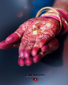 a woman's hand with henna and ring on it