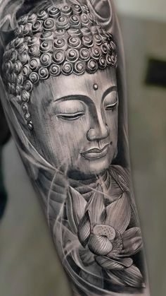 a black and white photo of a buddha tattoo