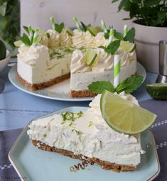 there is a slice of cake with lime on the plate next to it and another piece has a candle