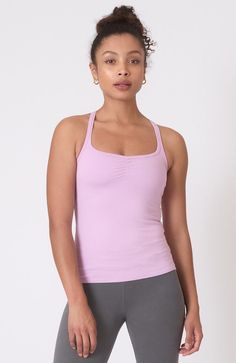 ~Lotus~ Fits close to body. Build in bra.Slight v-neck created from center front touching. T-back. 92% Organic Cotton 8% Lycra. Made in USA. Garment dyed extra soft. Length: 20.5"Colors:White, Black, Amethyst Tie Dye, Orange Poppy, Blue Moon, Denim Muse, Navy, Truffle, Tidepool, Lotus Model is 5' 9" size 4, and wearing a size small. Shown with the Sueded Hatha Legging in Sterling Body Build, Personal Things, Band Camp, Black Amethyst, Clothing Shopping, Athletic Clothes, Orange Poppy, Low Impact Workout, Fashion 101