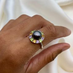 Black Pearl Ring set with a Natural Pearl in an AAA grade & natural black color, at 10mm diameter, from Japan, surrounded with Natural Citrine, Amethyst & Peridot, at 3mm each, 1.5 Carat combined, from Brazil. Band width 1.5mm. Pearl Flower Ring made of Solid 925 Sterling Silver ☞ made to last. Matching Earrings: www.etsy.com/listing/257621328 Matching Pendant: www.etsy.com/listing/558058800 June, November, February & August Birthstone * Genuine & Natural Stones * D E T A I L S ✓ Adina Stone GIF Luxury Pearl Birthstone Ring, Luxury Mother Of Pearl Gemstone Rings, Luxury Oval Cabochon Pearl Ring, Luxury Multi-stone Pearl Ring Gift, Luxury Round Pearl Birthstone Ring, Luxury Multi-stone Heirloom Pearl Ring, Luxury Round Pearl Ring With Cabochon, Luxury Classic Multi-stone Pearl Ring, Luxury Multi-stone Pearl Ring Fine Jewelry