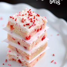 three pieces of cake sitting on top of a white plate with sprinkles